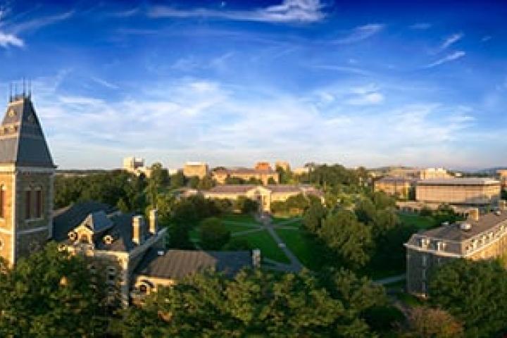 aerial view of the Cornell clock tower and surrounding landscape with a blue sky with clouds